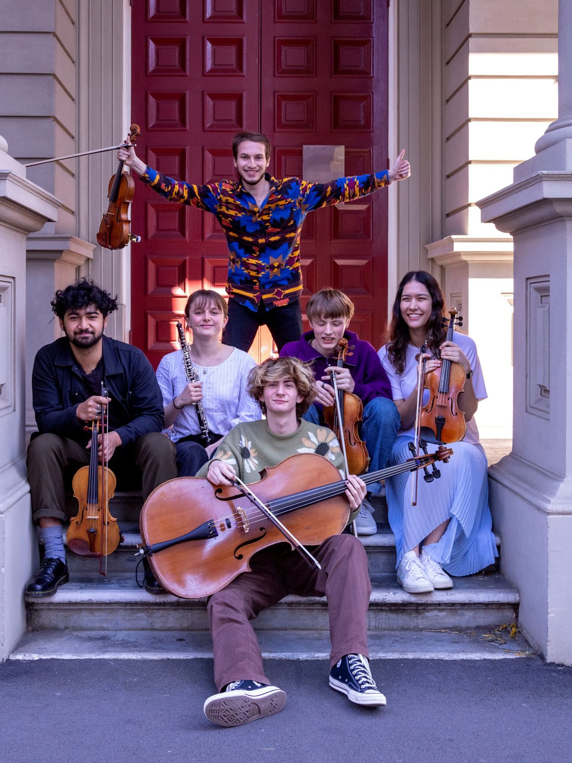 Young WYOS musicians with their instruments on the steps of St Andrew’s on The Terrace